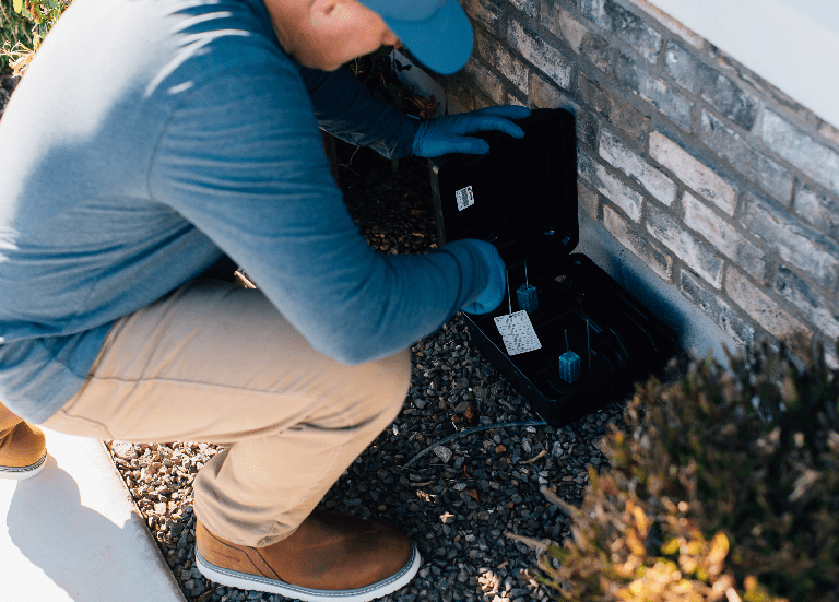 man checking the edge of a house